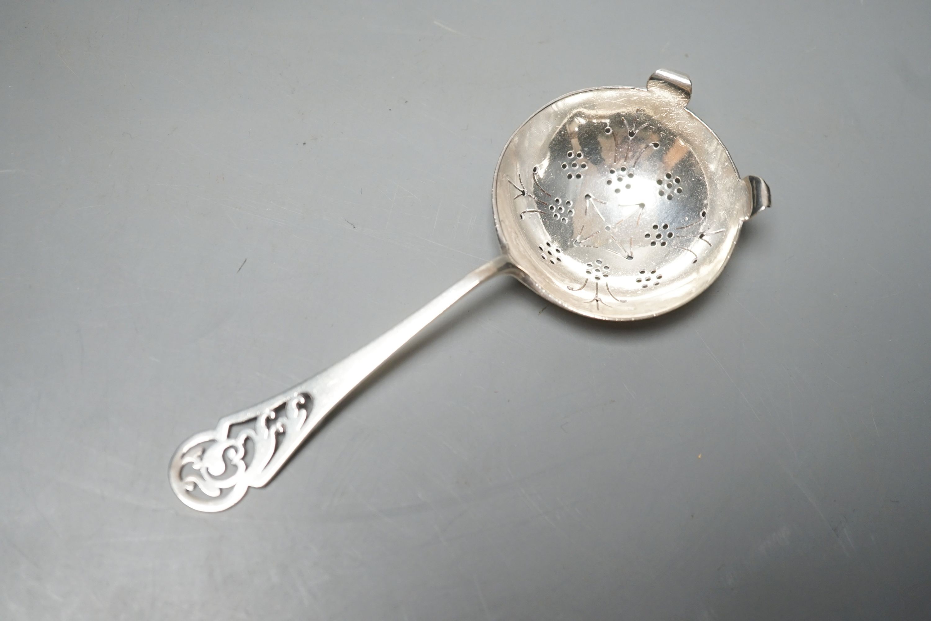 A Edwardian Art Nouveau pierced silver comport, William Hutton & Sons, London, 1903, 15.7cm diameter and a silver sifter spoon, 6.5oz.